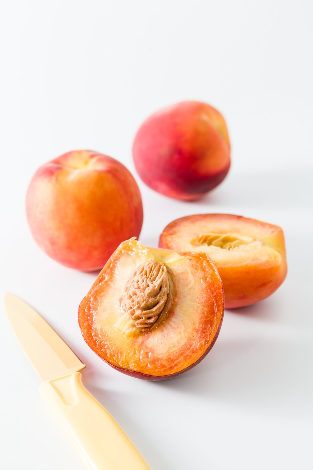 Peaches sliced in half