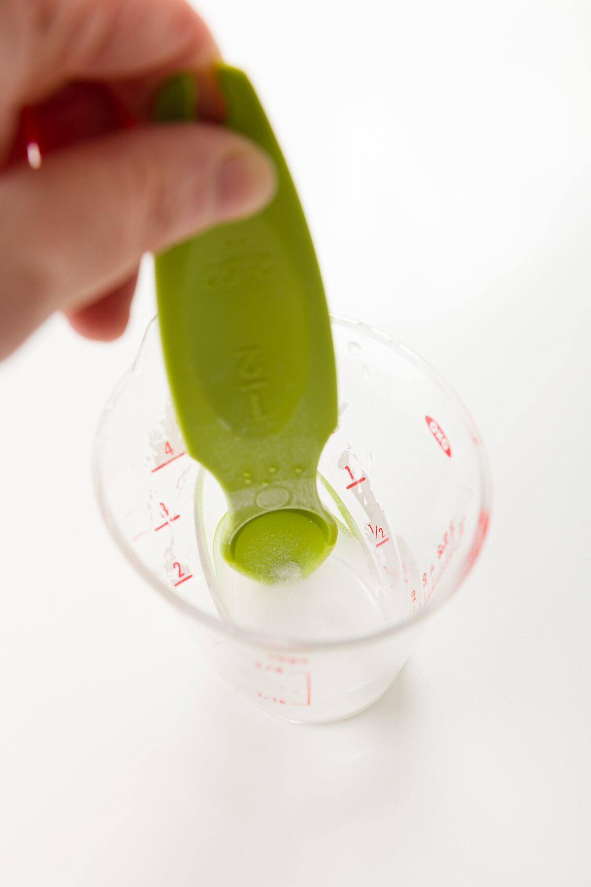 tight photo of Stef mixing baking soda into water to form a slurry
