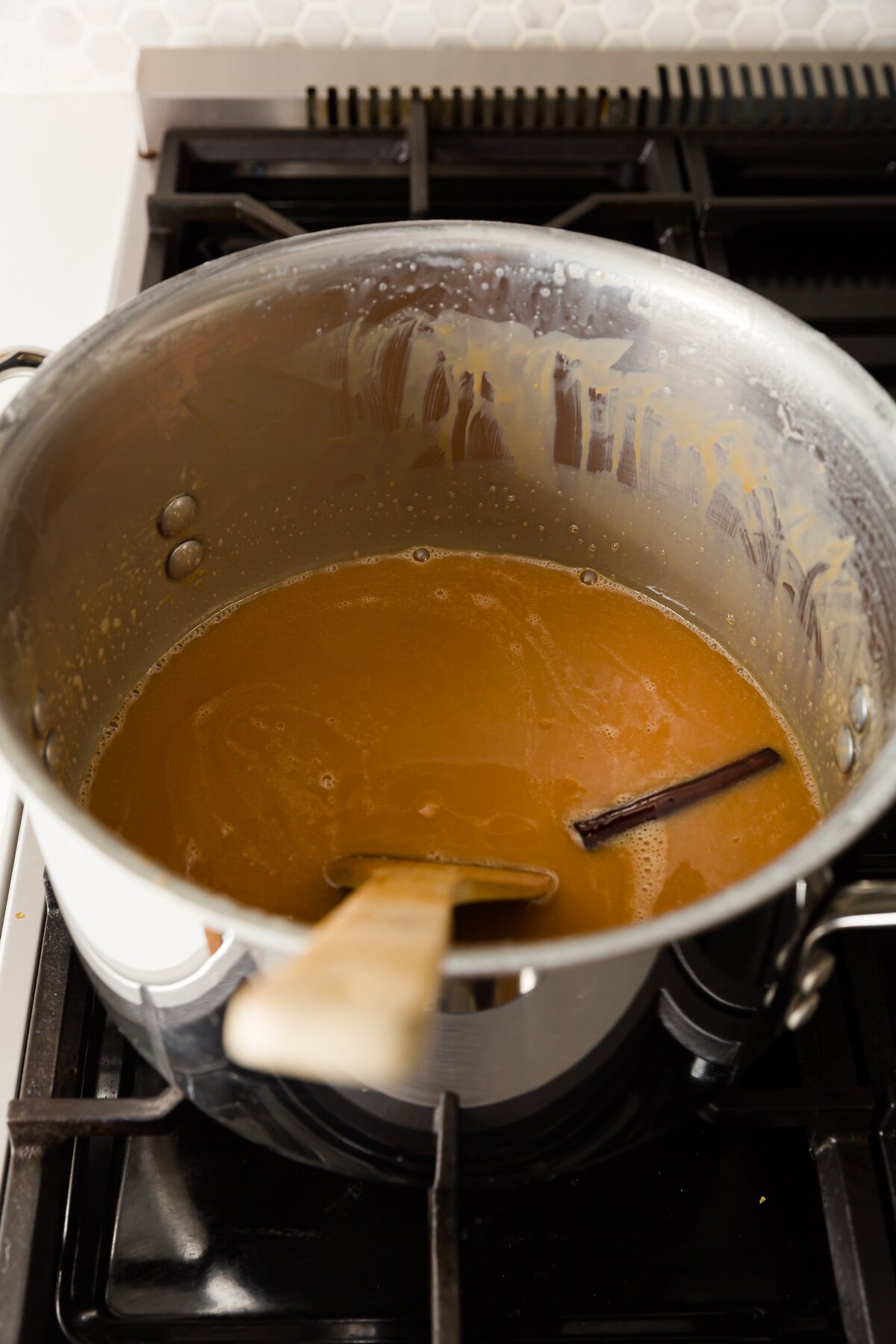 looking into the pot with cajeta to see its reduction in volume and darker color