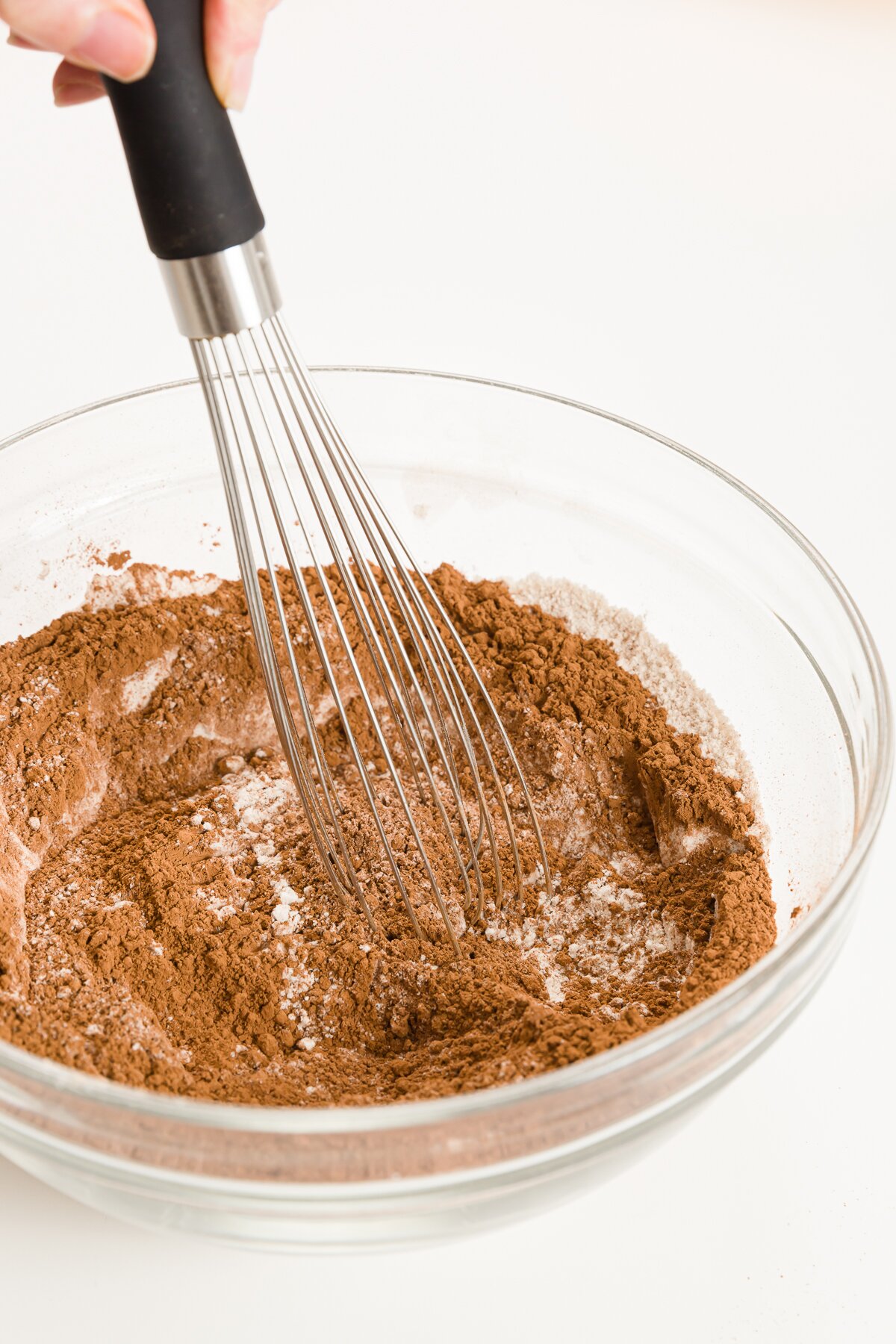 Whisking dry ingredients in a glass bowl