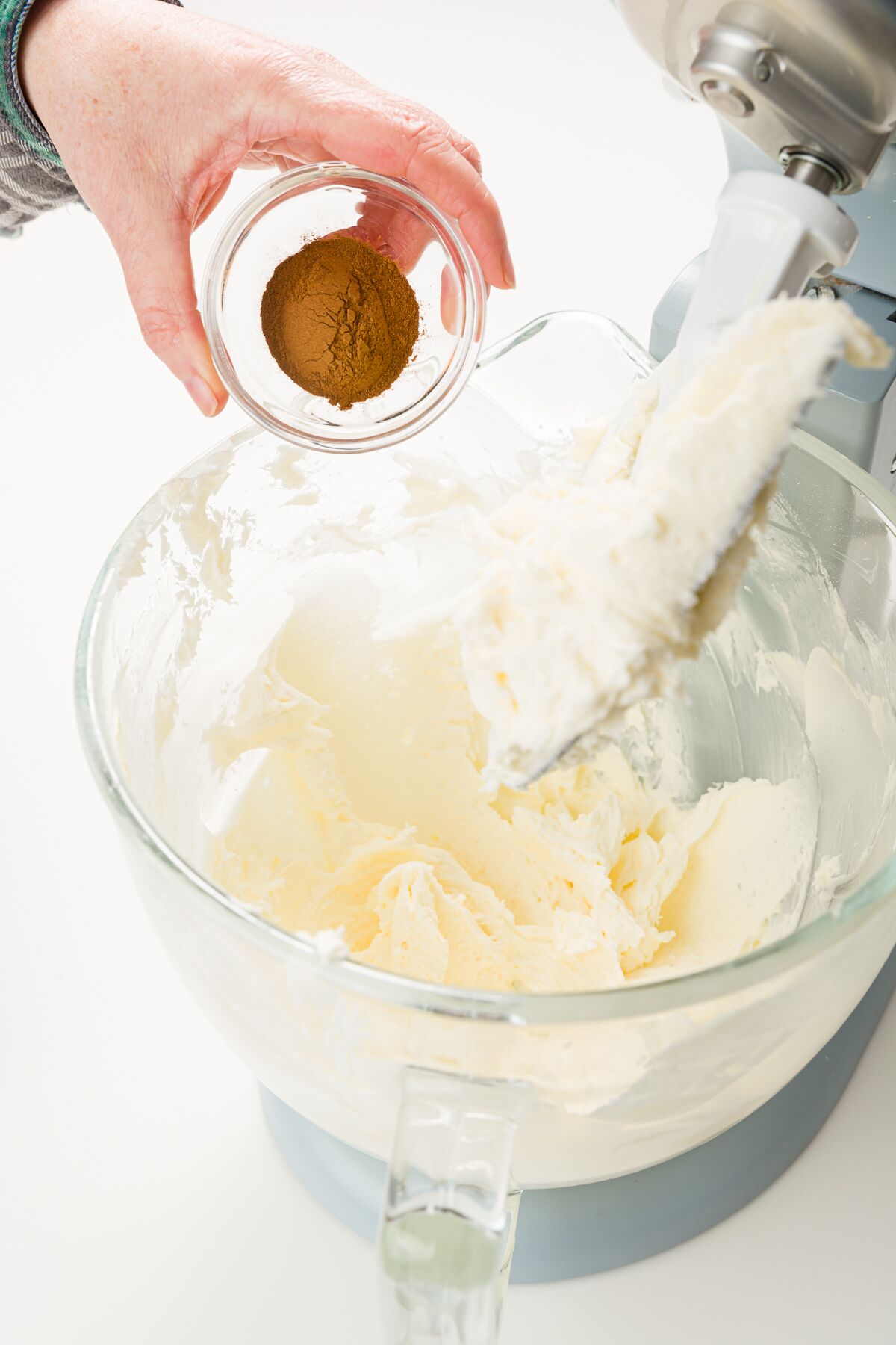 Adding cinnamon to mixer bowl
