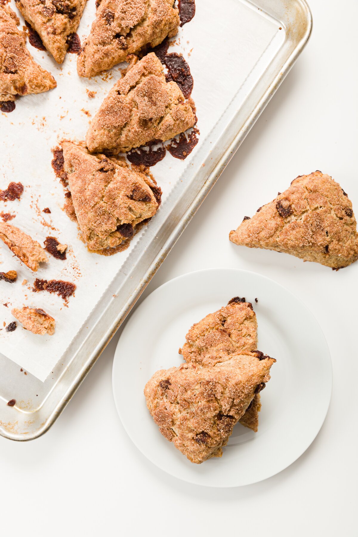 Baking sheet filled with scones with a few scones in the foreground