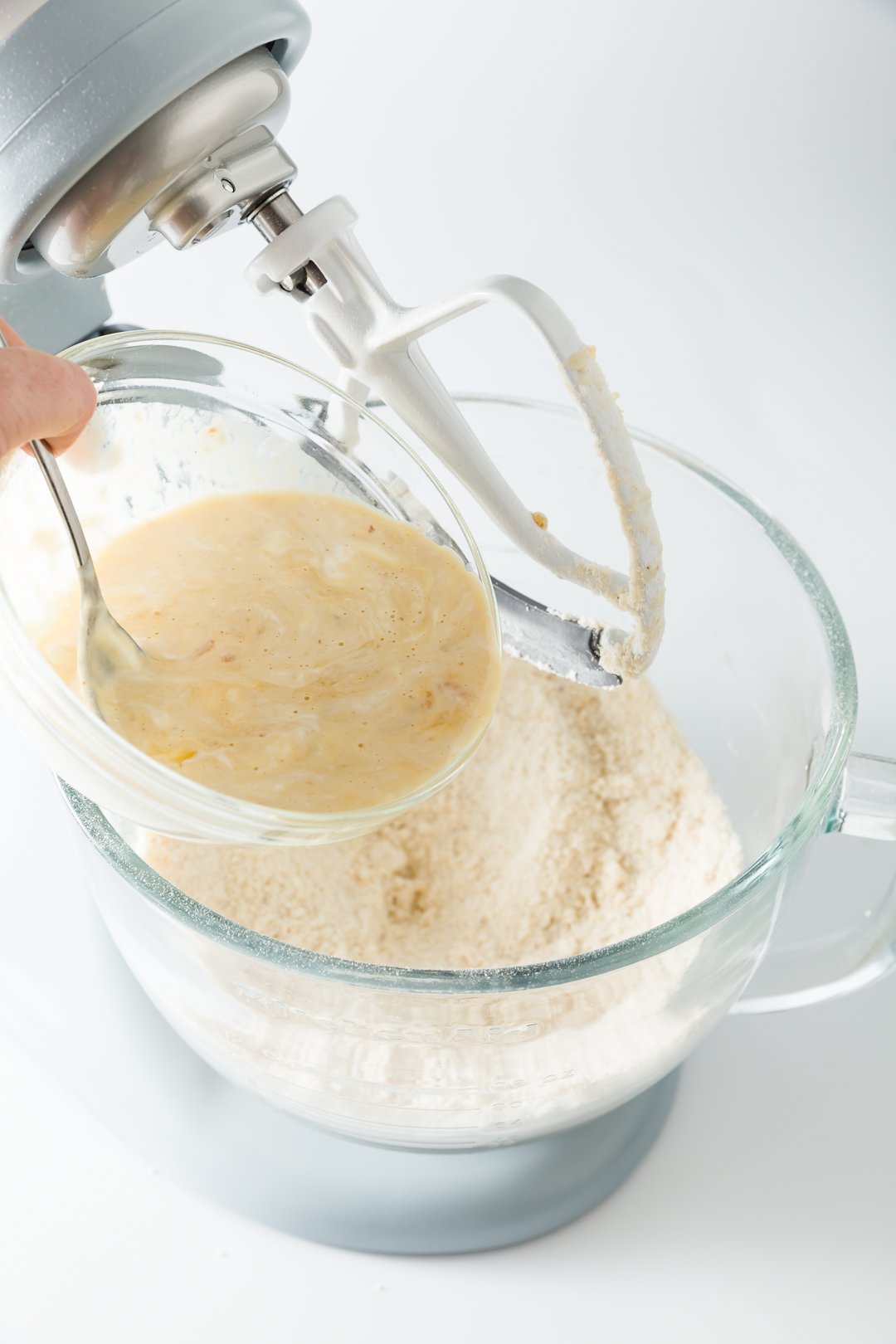 Adding wet ingredients to dulce de leche cake