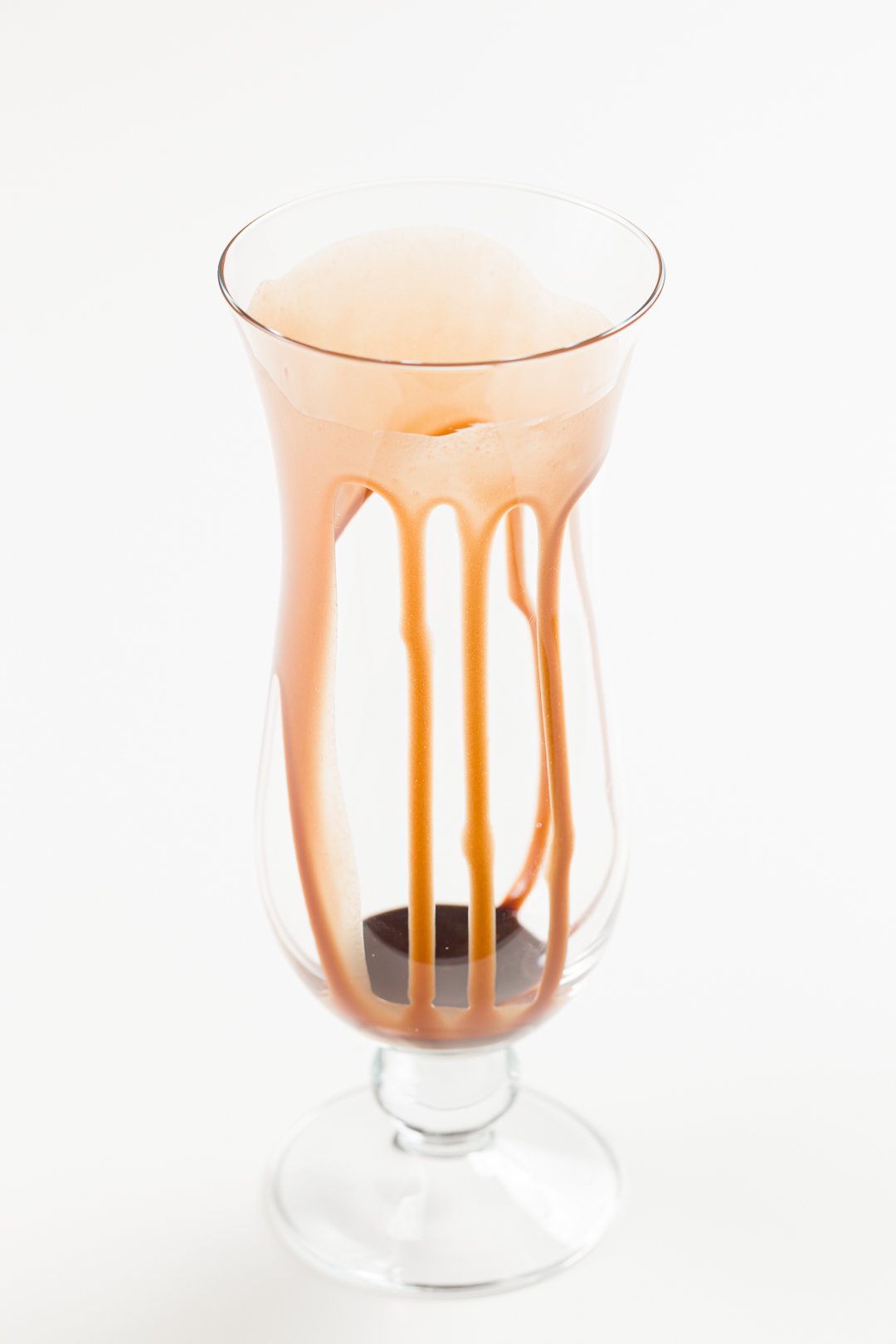 a glass drizzled with chocolate sauce on its inside