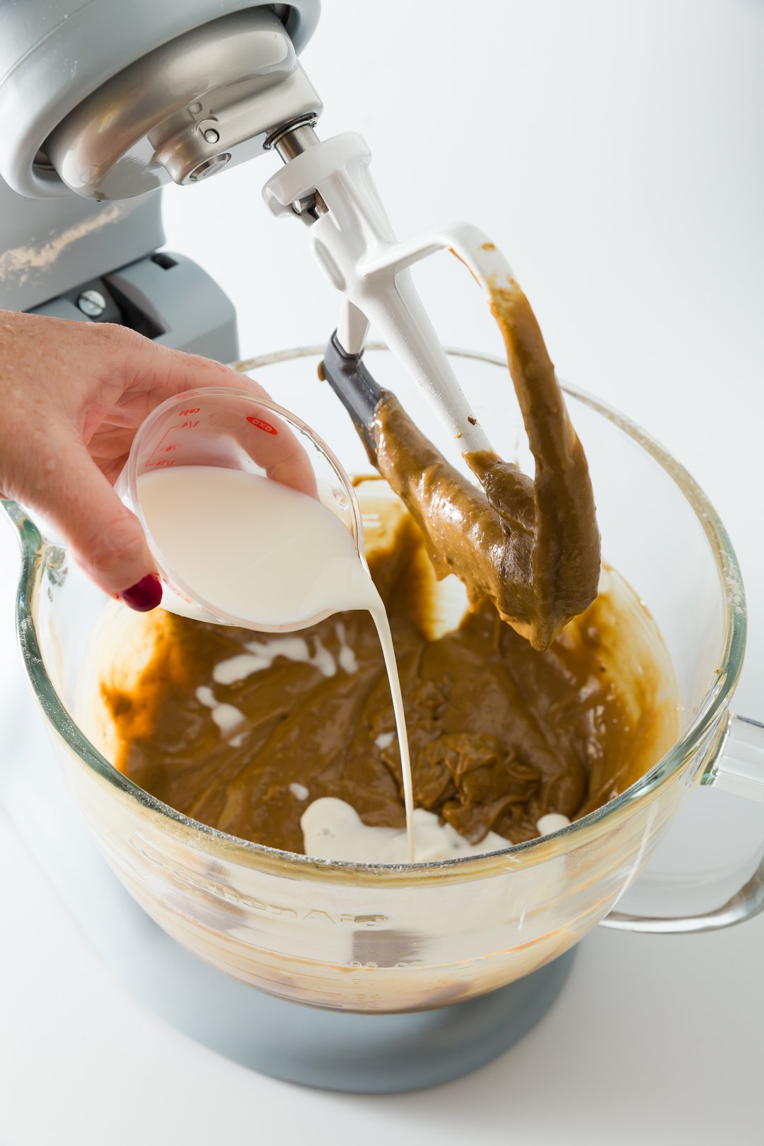 Adding milk to cupcake batter