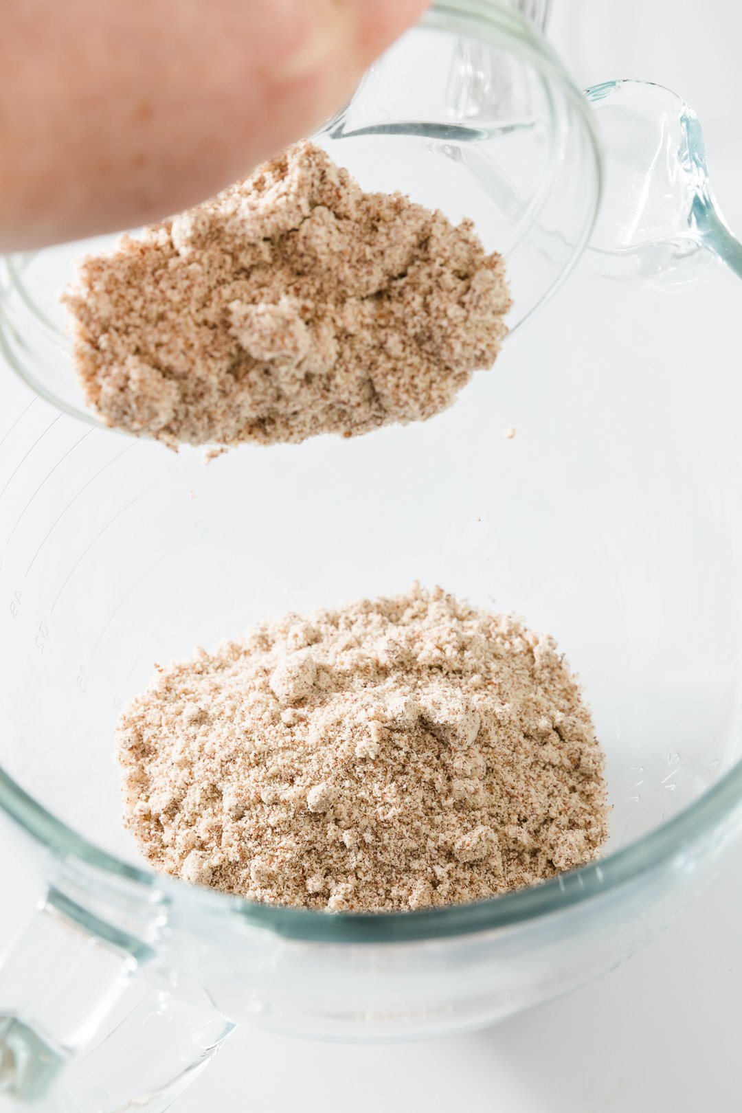 Pouring almond flour into a bowl