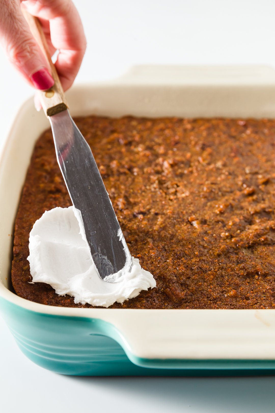 whipped coconut cream spread on carrot cake