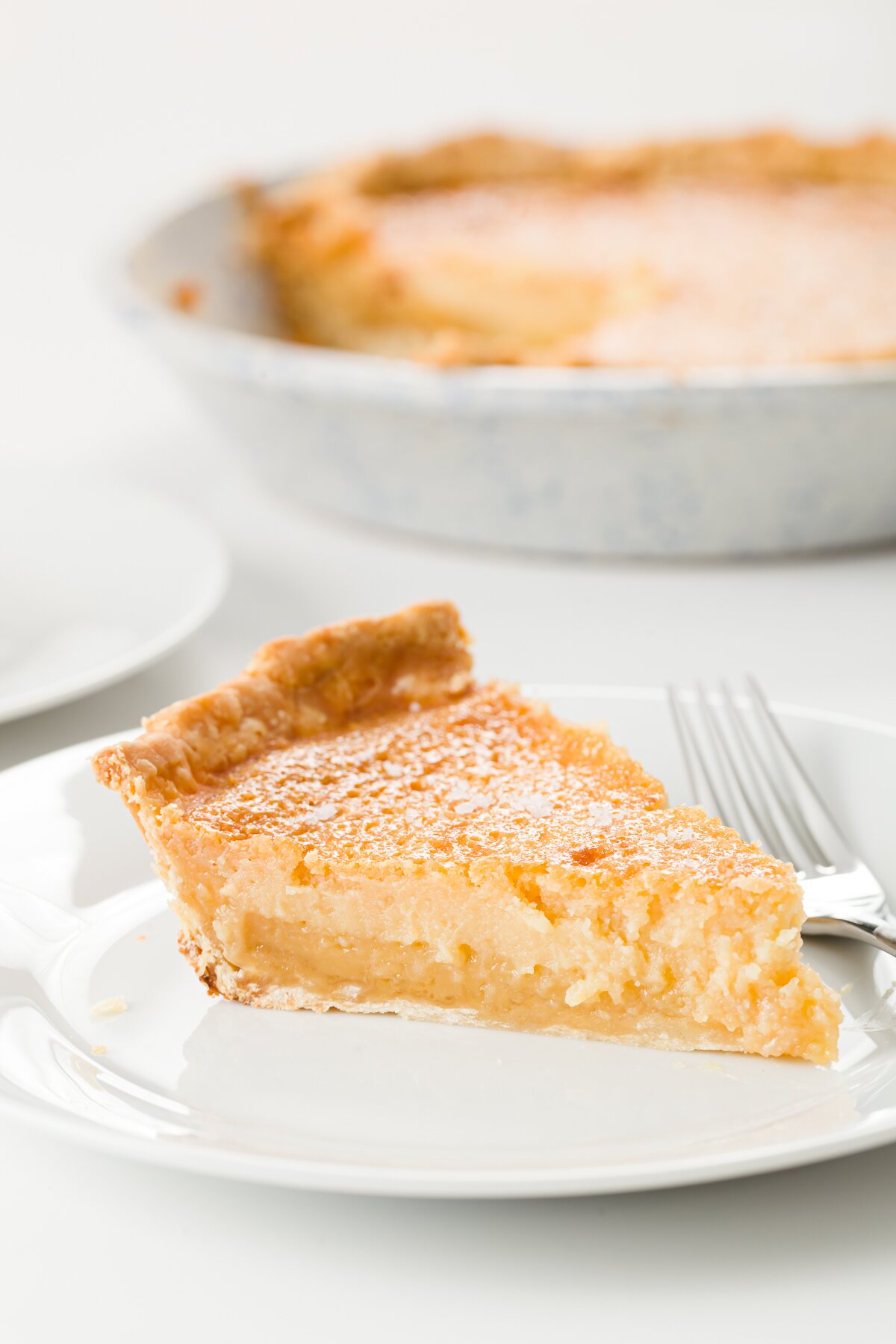 Slice of honey pie on a white plate
