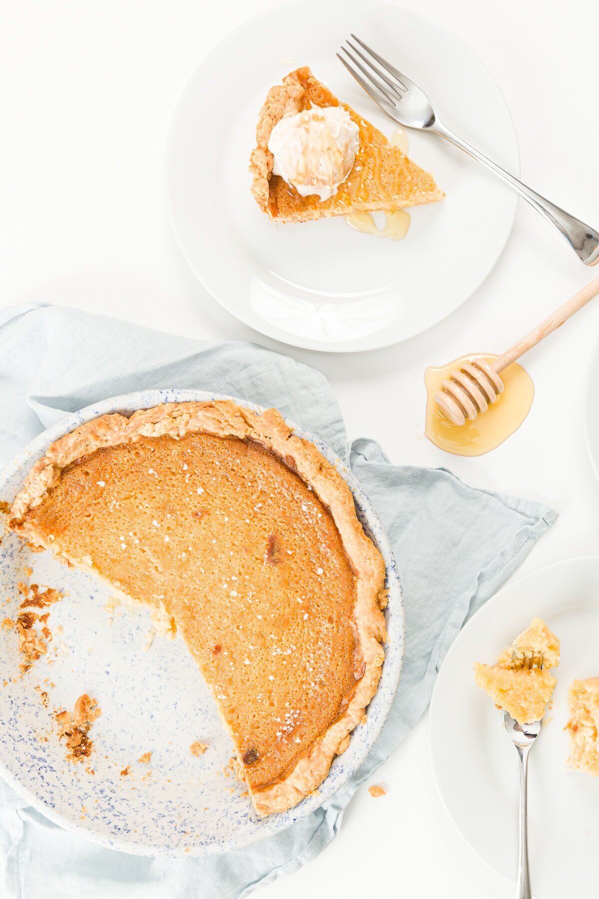 Over head photo of a honey pie with a piece removed and on a plate