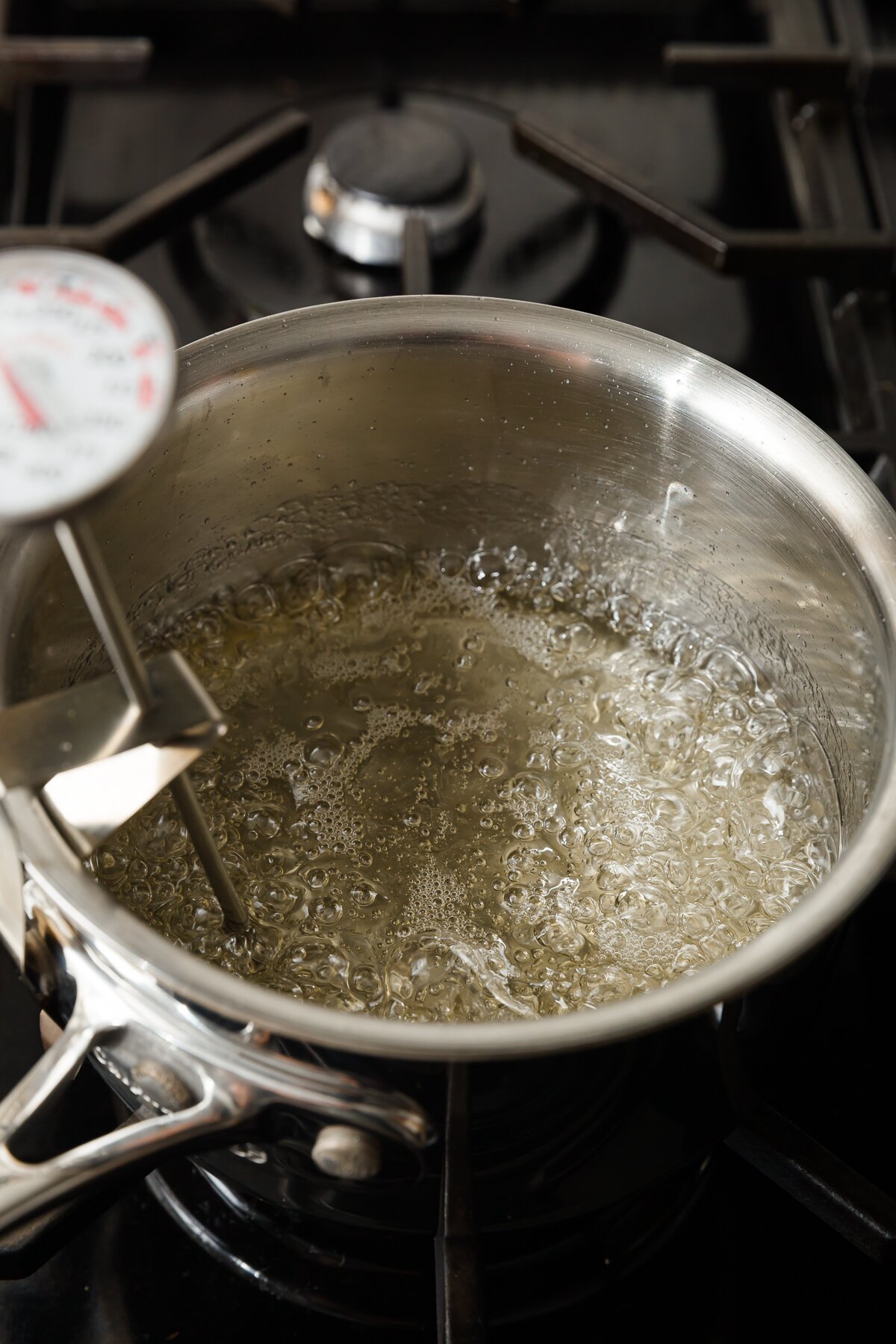 water and sugar boiling in a medium pot on a stovetop