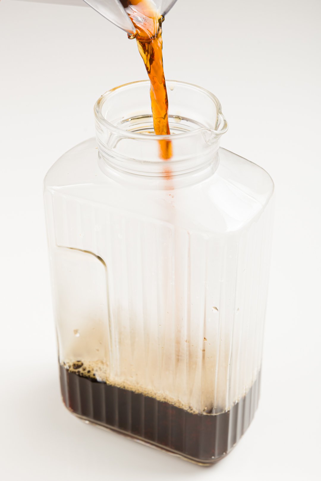 pouring coffee in a jug to make homemade Kahlua