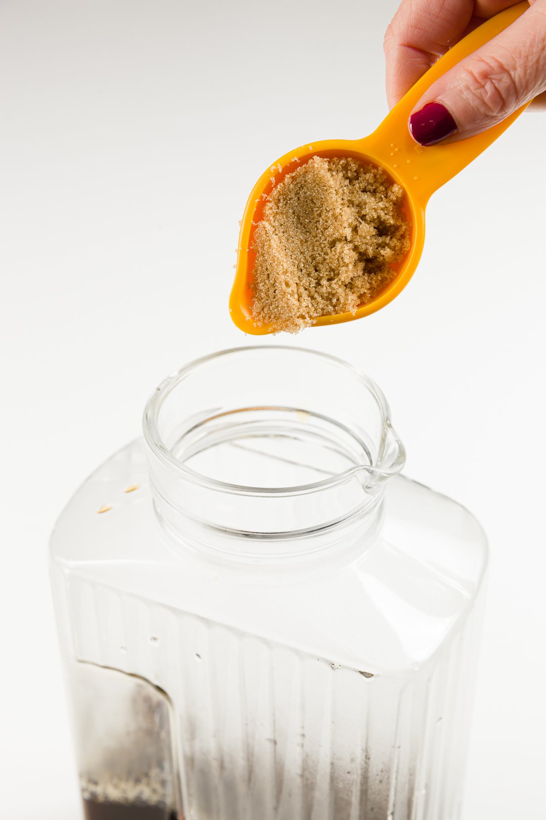 adding sugar to coffee in a jug to make homemade Kahlua