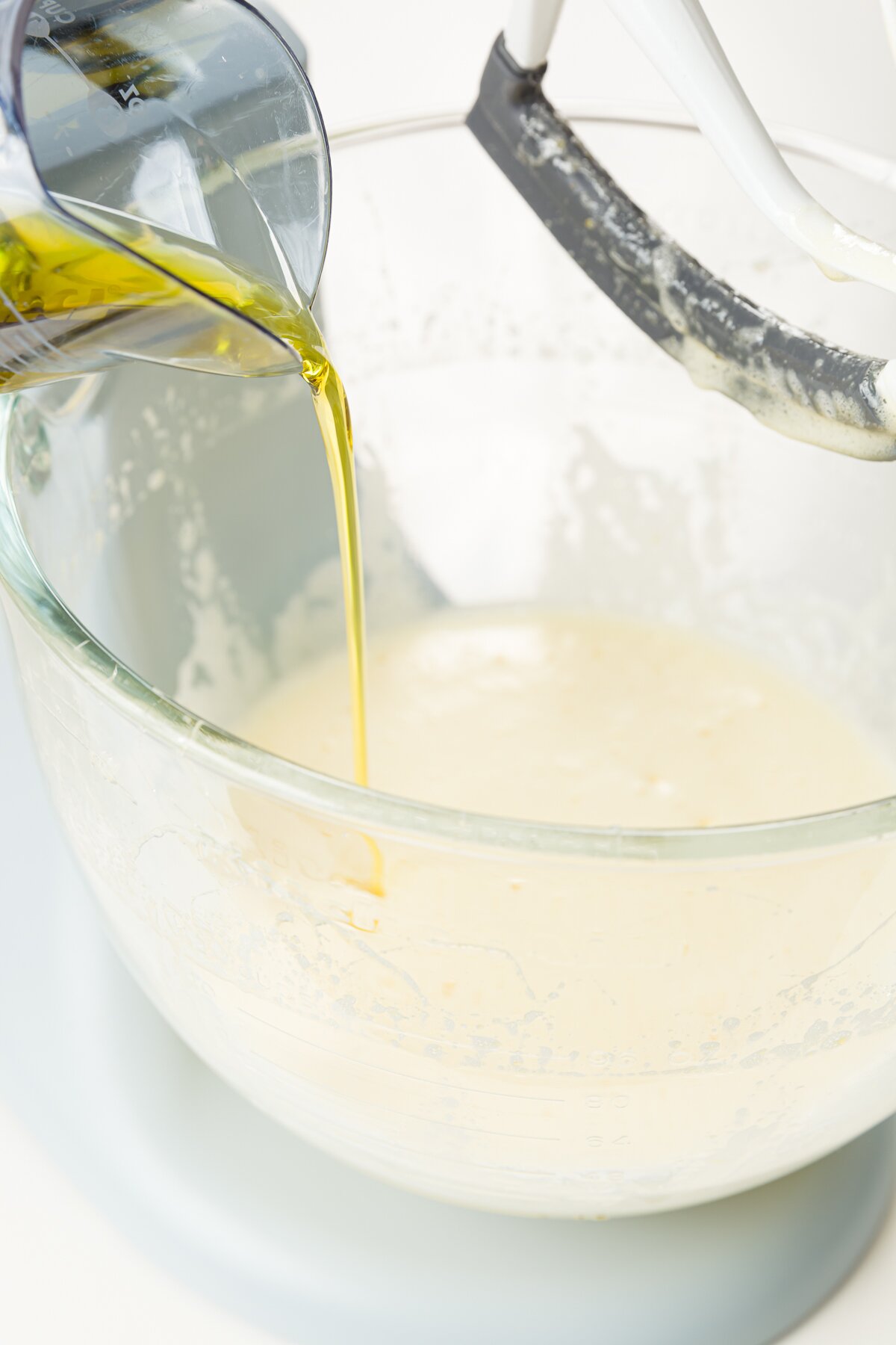 Adding olive oil to the bowl of a kitchen aid mixer