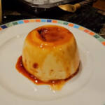 A finished microwave flan turned upside down on a plate.