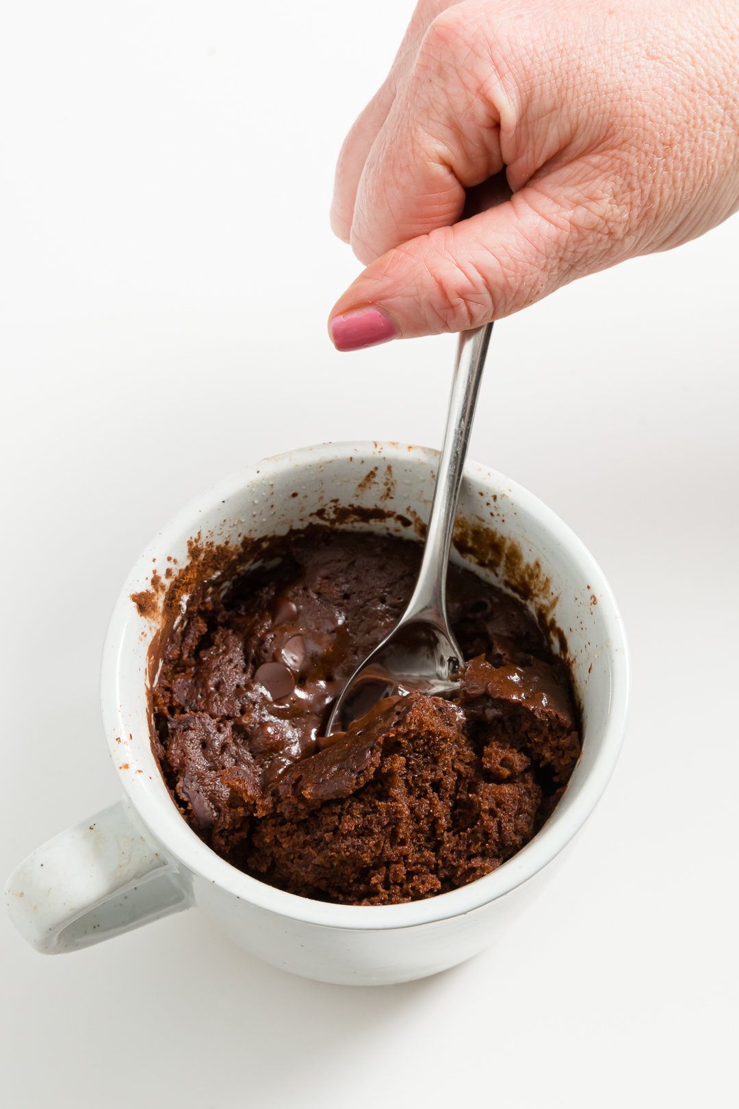Getting a spoonful of chocolate mug cake