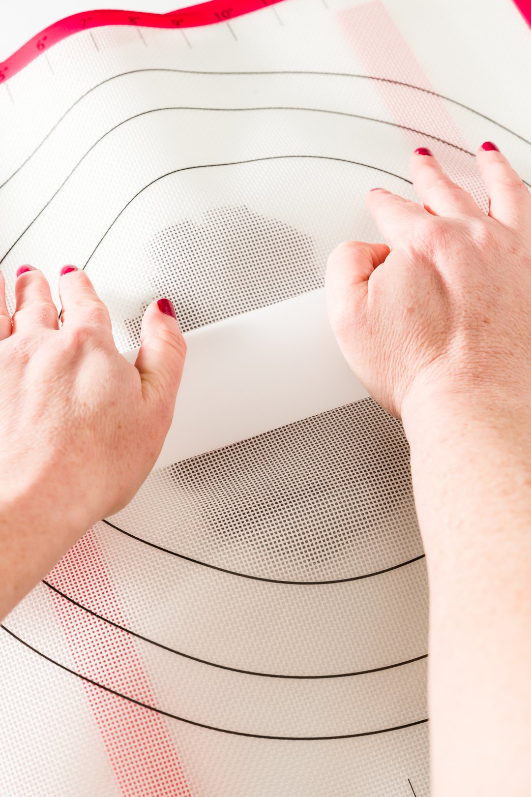 Rolling dough between two silicone mats