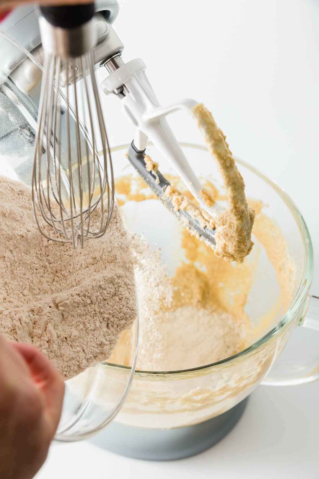 Adding dry ingredients to peach muffin batter