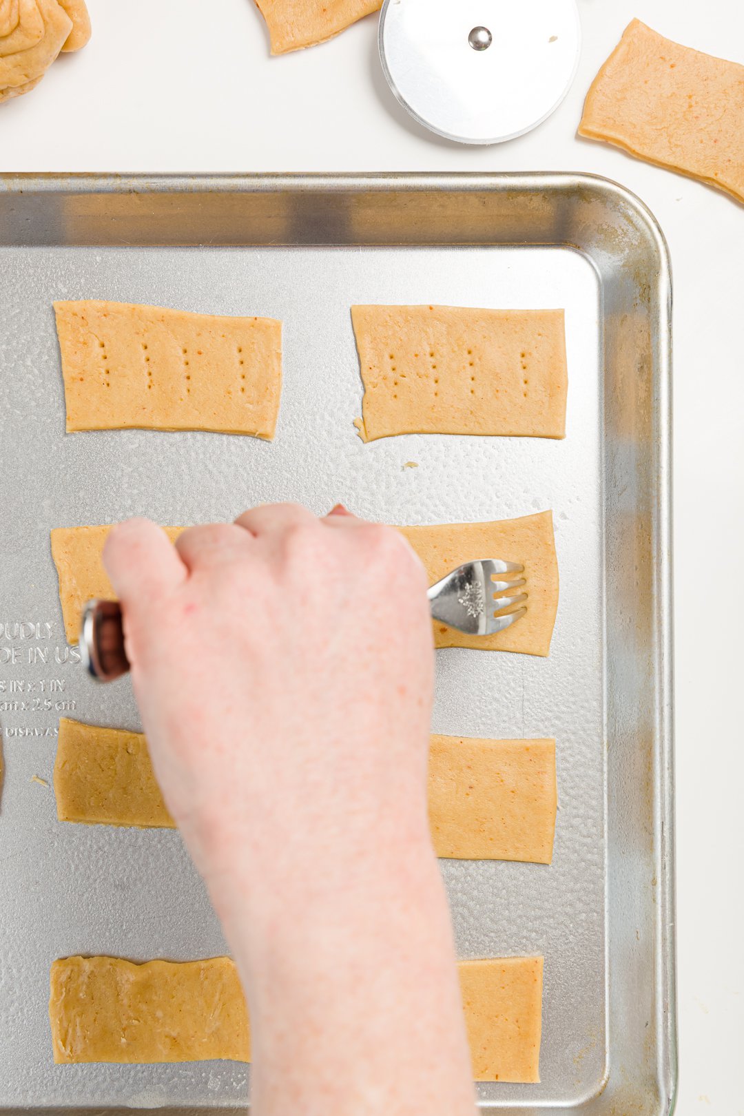 Poking holes in cracker dough