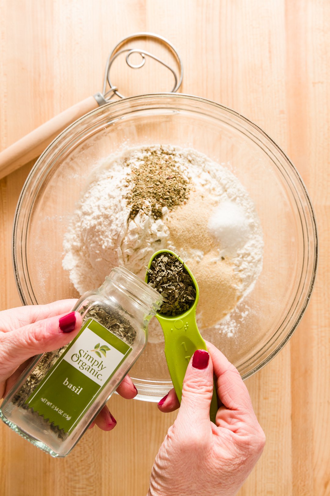 Adding basil to pizza dough