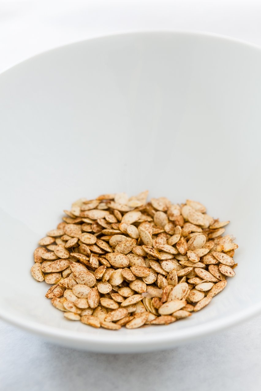 Sweet & Salty Toasted Pumpkin Seeds Toasted Pumpkin Seeds in a white bowl