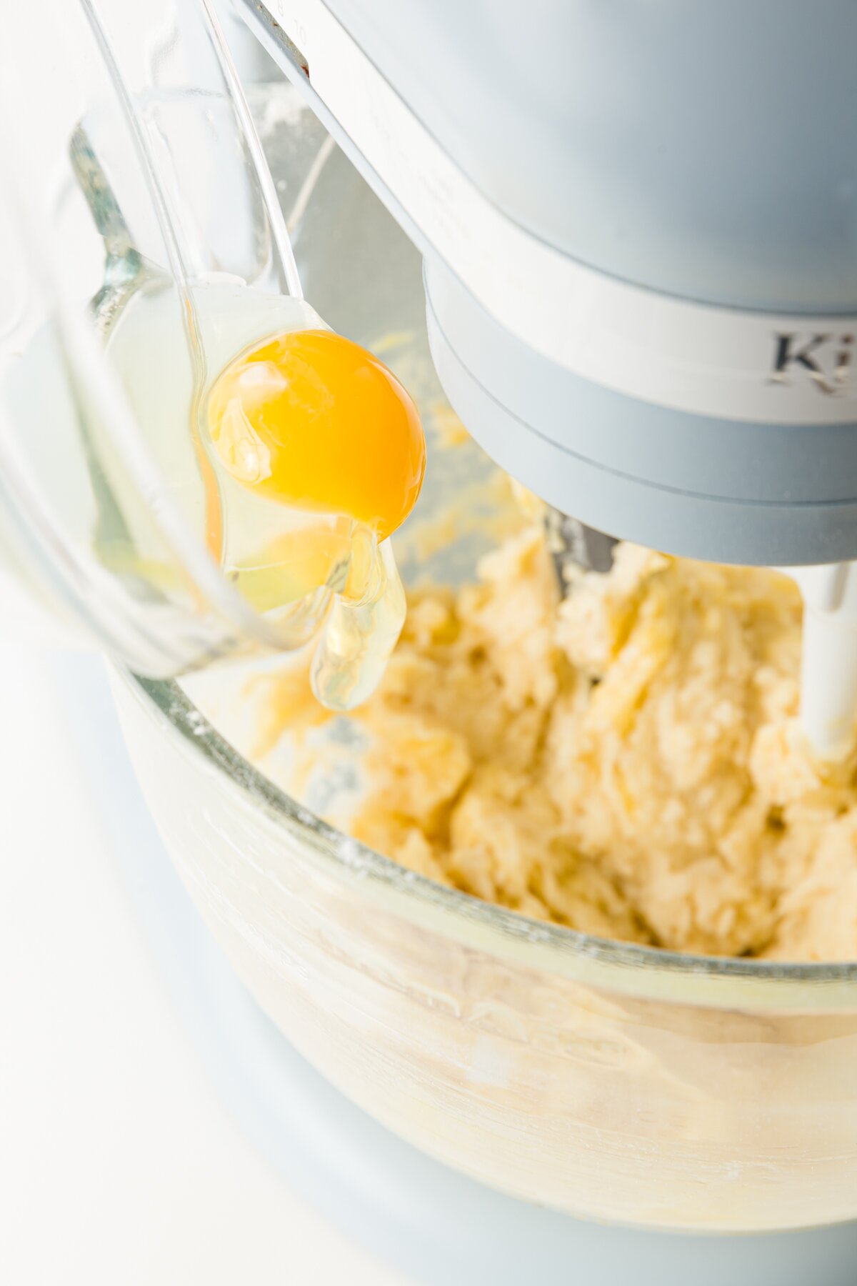 eggs being added into batter in a stand mixer