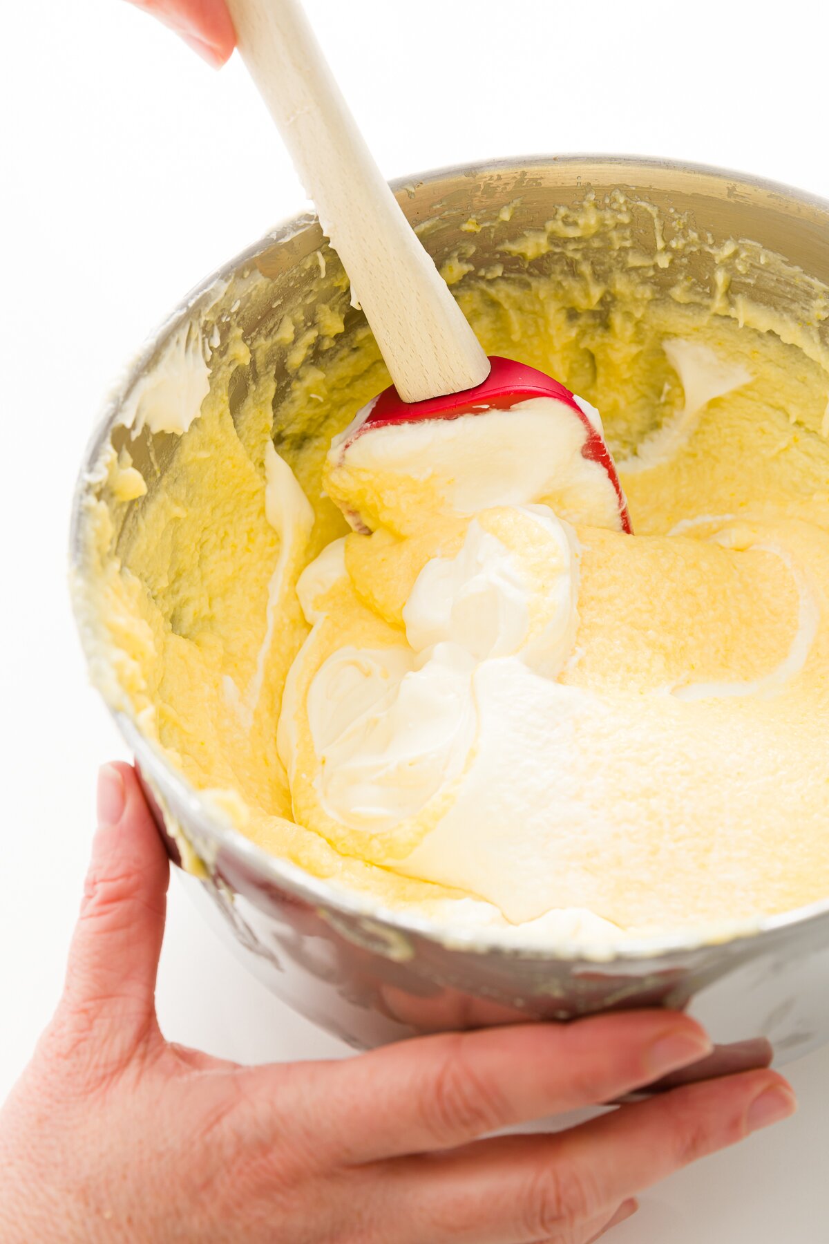 Stef folding whipped cream into the mixture of sugar, egg whites, and mascarpone